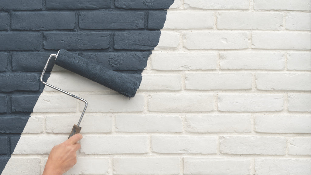 Person with paint roller painting Creative Mines Loft Paintgrade Brick a black color